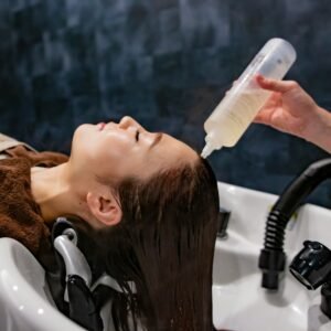 a woman getting her hair washed with a hair dryer